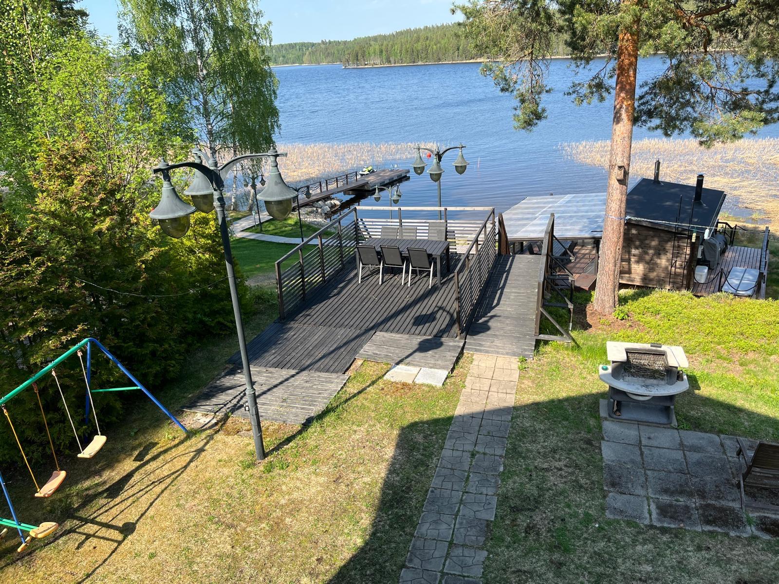 Yard, swing and jetty in the lake scenery at Villa Purnukka